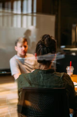 A group of people talking at an office